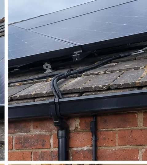 Close view of solar PV panel mounting brackets and protected roof cabling